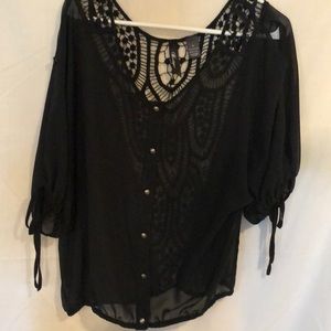 Black blouse with crochet inlay.